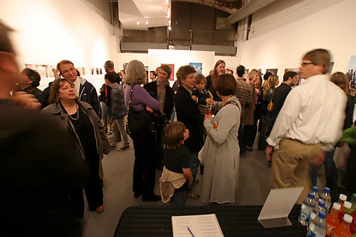 Reception for Previous Top 40 exhibition People viewing artwork in gallery